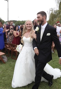 a bride and groom walking down the aisle at a wedding