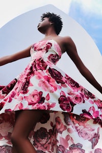 a black woman in a floral dress